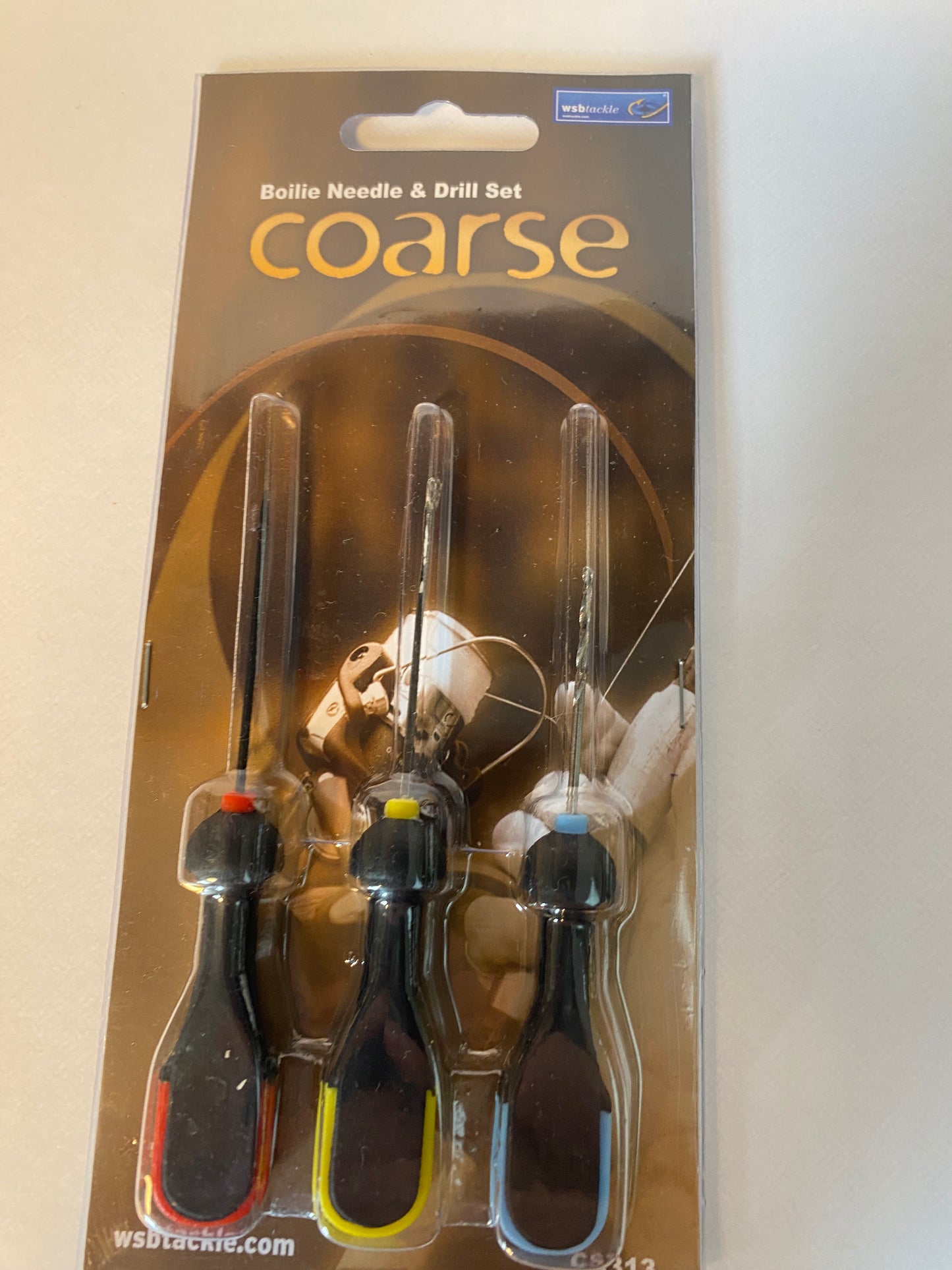 Bait needle and drill set on a cardboard background