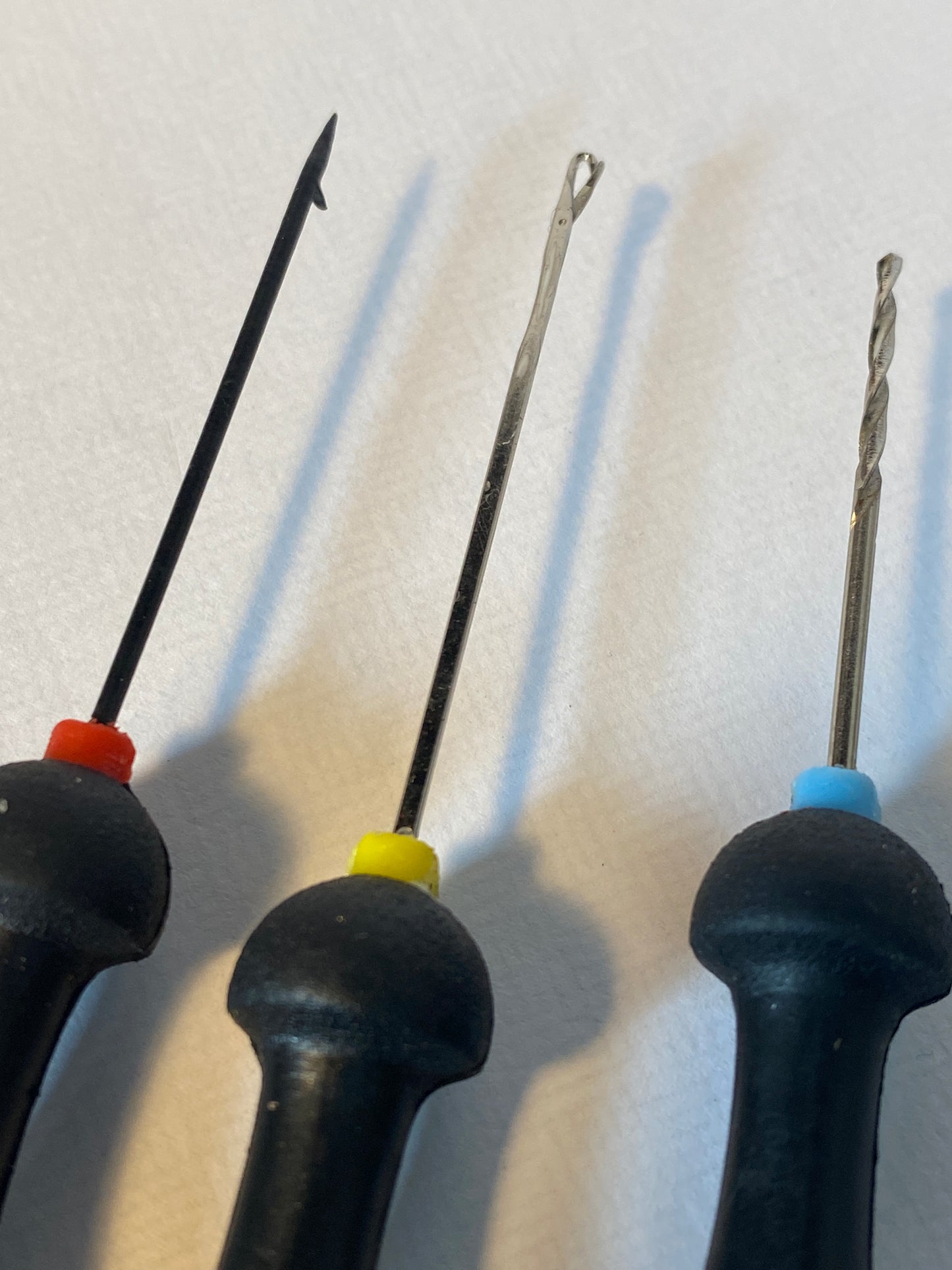 Close up of a two baiting needles and a bait drill