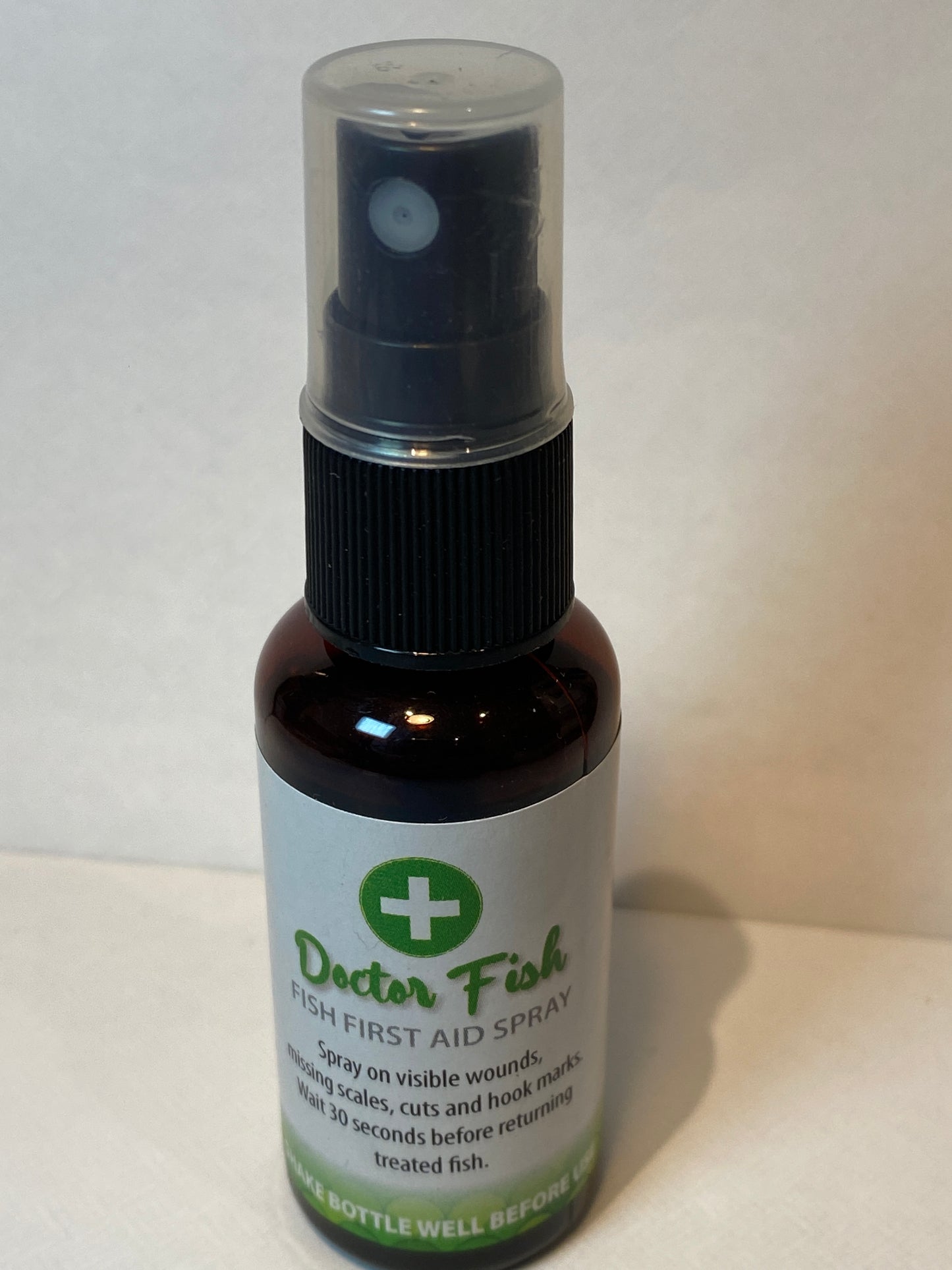 A bottle of fish first aid spray against a white background