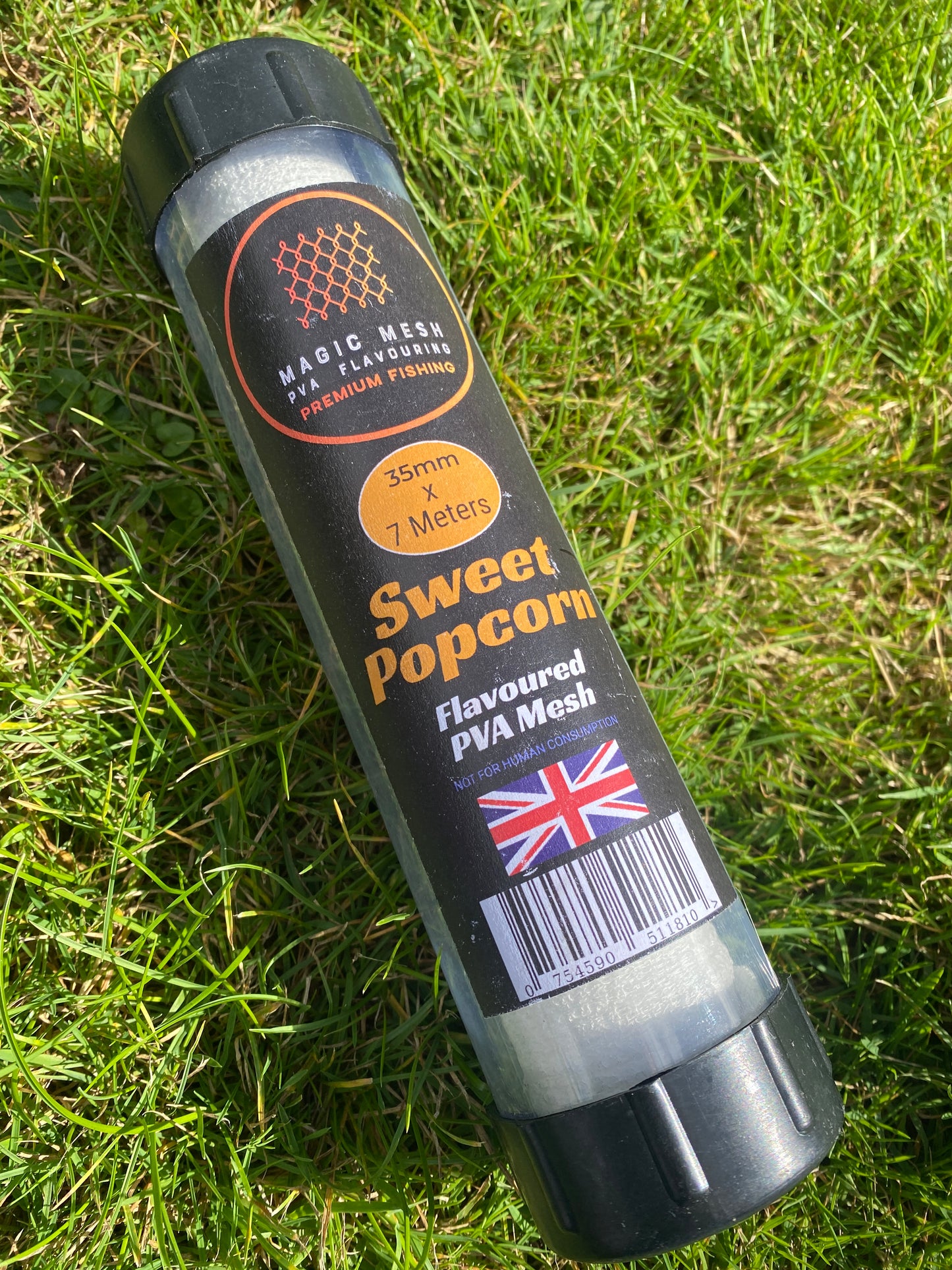 Container of sweetcorn popcorn-flavoured PVA mesh on grass