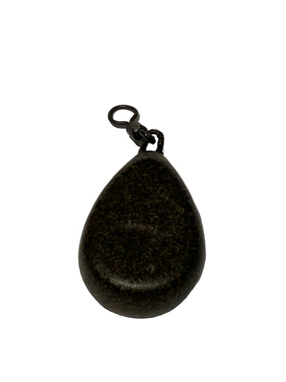 A dark, teardrop-shaped fishing lure or bait with a small attached black split ring and clip, shown on a textured off-white background.