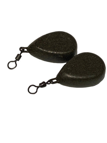 A pair of dark metallic teardrop-shaped fishing weights with swivel clamps, shown on a light textured background.