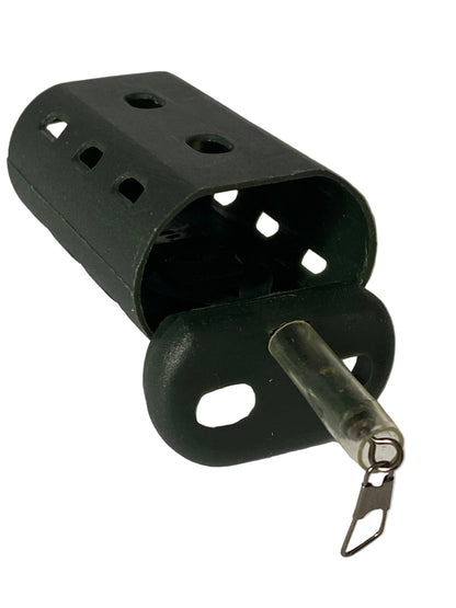 A dark green plastic fish bait holder with a clear plastic tube and a metal split ring, resting on a light gray surface.