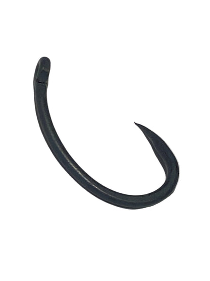 A single black plastic fishing hook lying on a textured white surface.