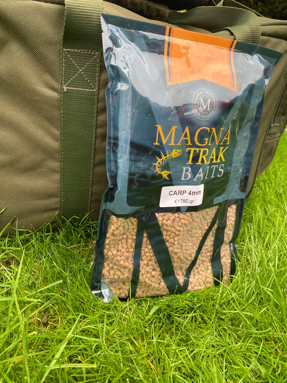 Magna Trak baits packaging on a green grass background